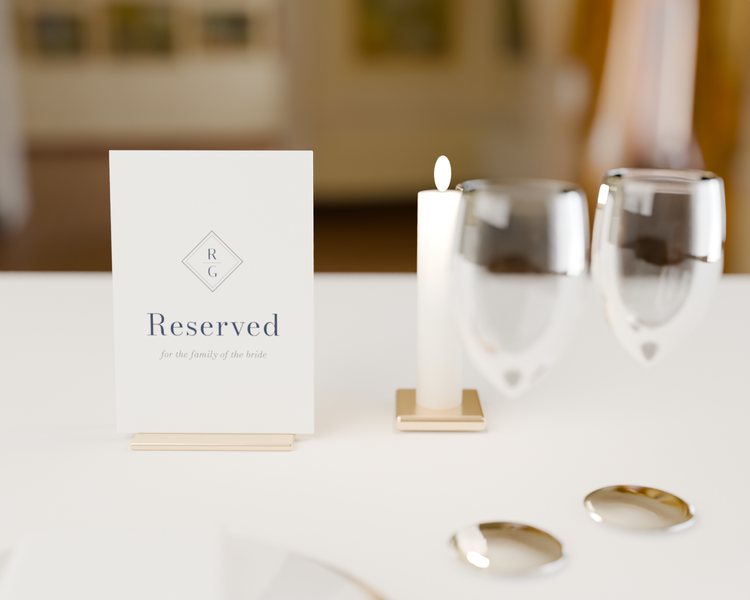 Reserved · Navy monogram, photographed on an easel (the easel is scenery, never sold)