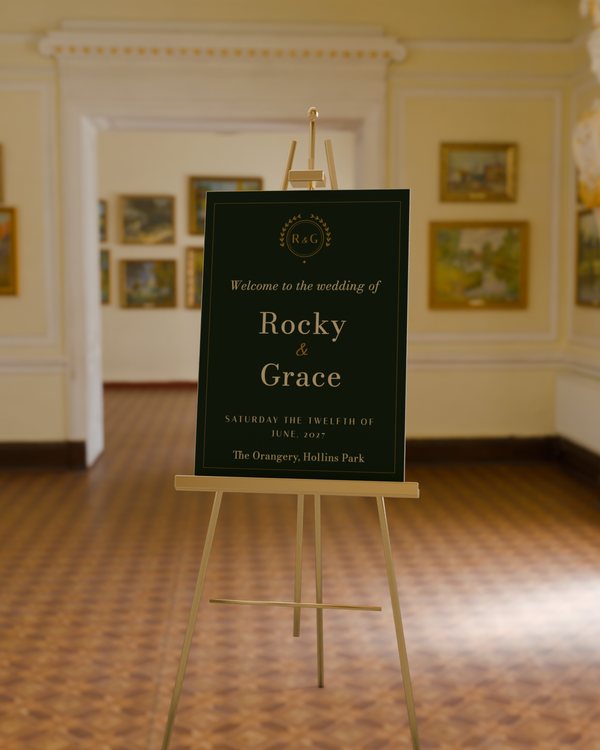 Welcome sign · Gilt crest, photographed on an easel (the easel is scenery, never sold)