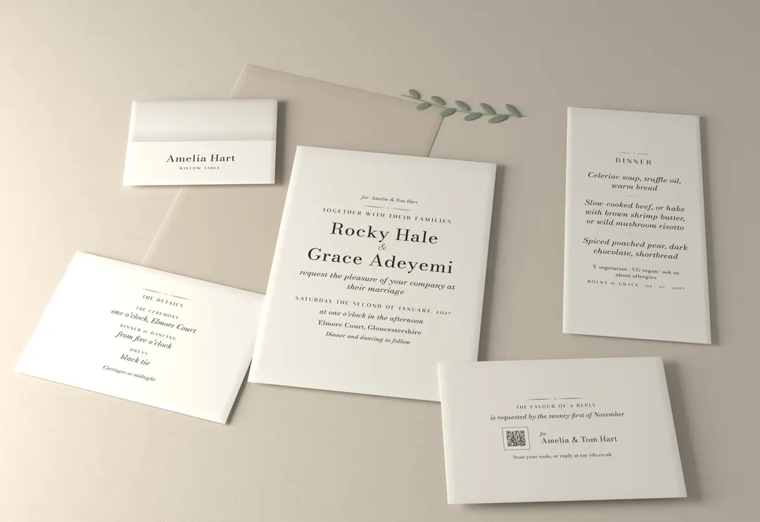 The classic wedding stationery suite, photographed: invitation, reply card, details card, place card and menu