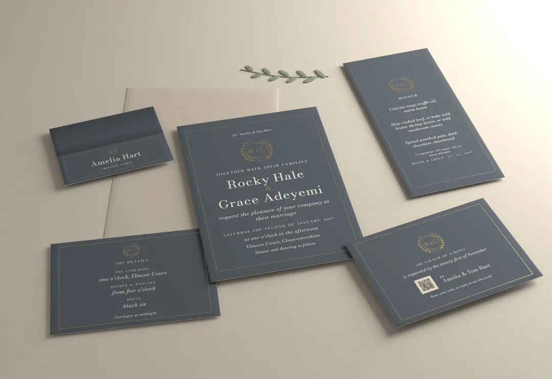 Gilt crest wedding stationery suite, photographed: invitation, reply card, details card, place card and menu