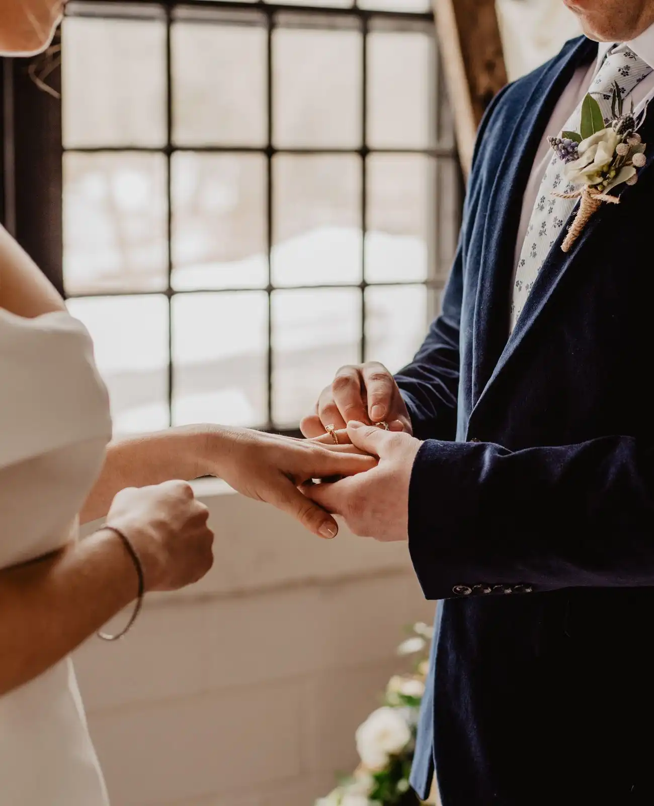 A ring is slid onto the bride's finger during the ceremony.